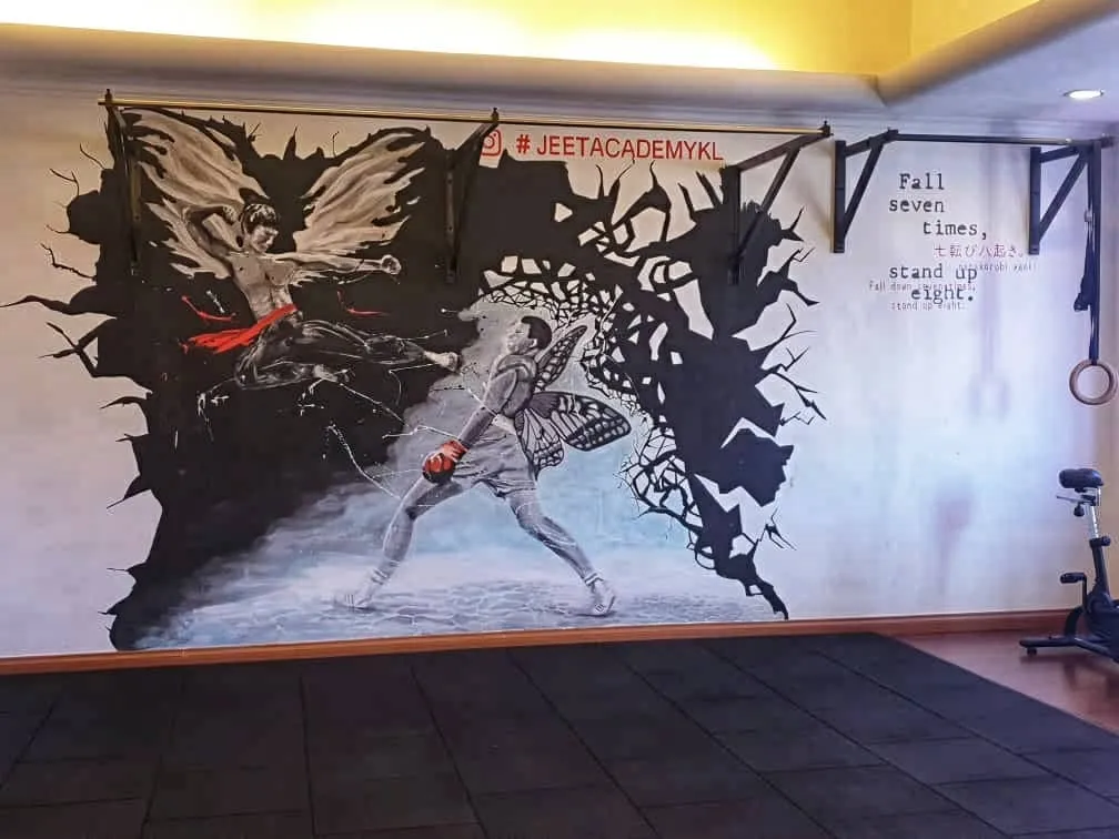 The fighters mural on the Jeet Academy KL studio wall, with pull-up bars and the #JEETACADEMYKL tag