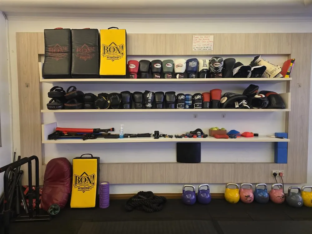 Gear wall at Jeet Academy KL - boxing gloves, pads and kettlebells