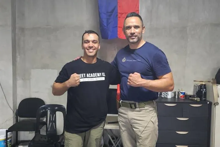 A Jeet Academy KL instructor with an instructor from Tricom Training in the Philippines